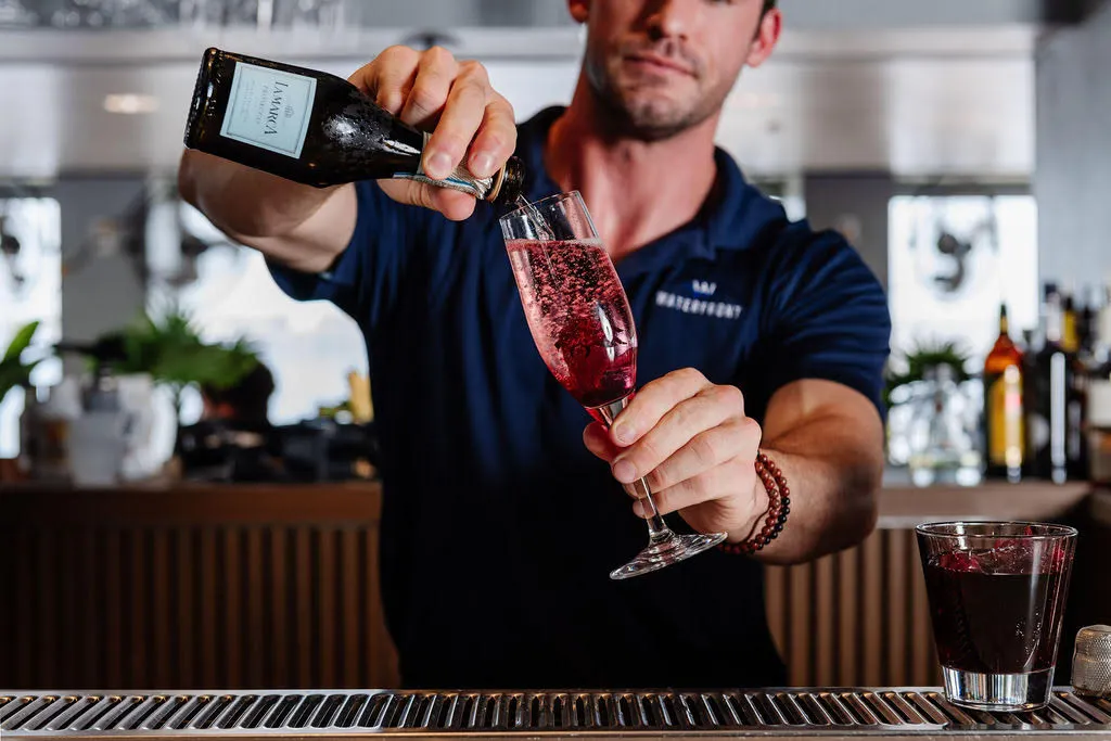A bartender pouring red wine at WaterFront in Stuart